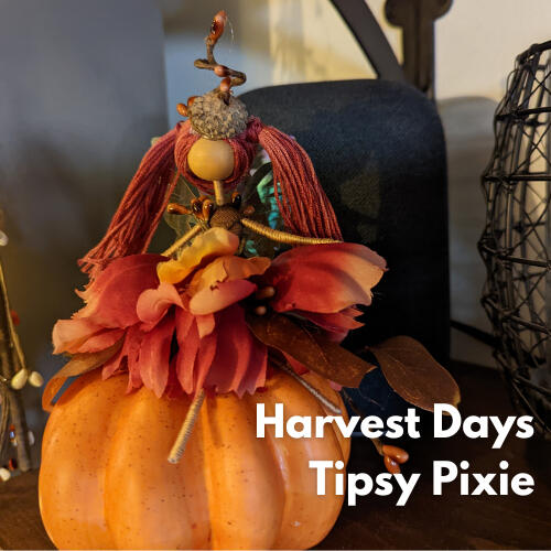 Handmade fall pixie figure crafted from wire and thread with autumn florals and ribbons.